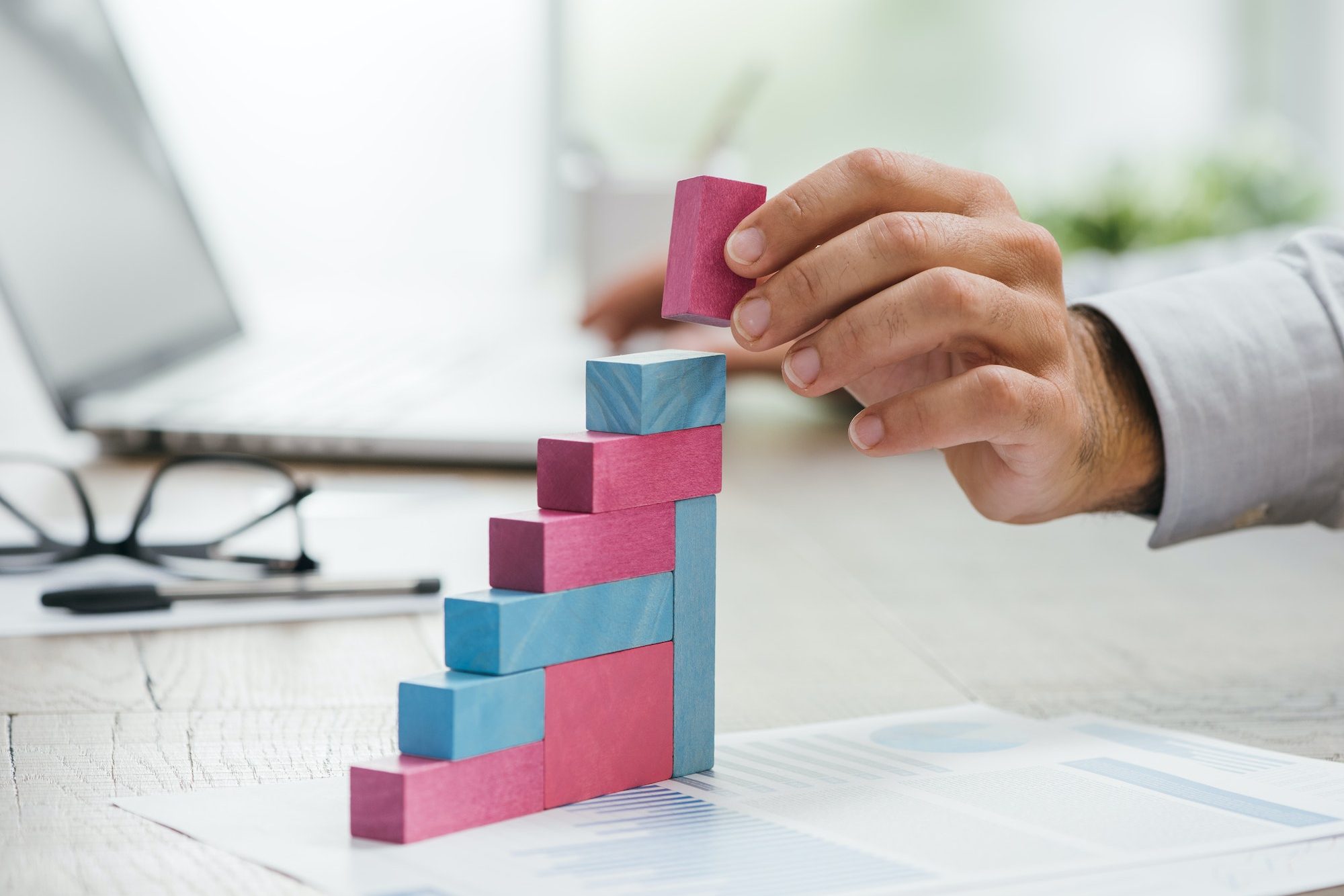 Businessman building a growing financial graph